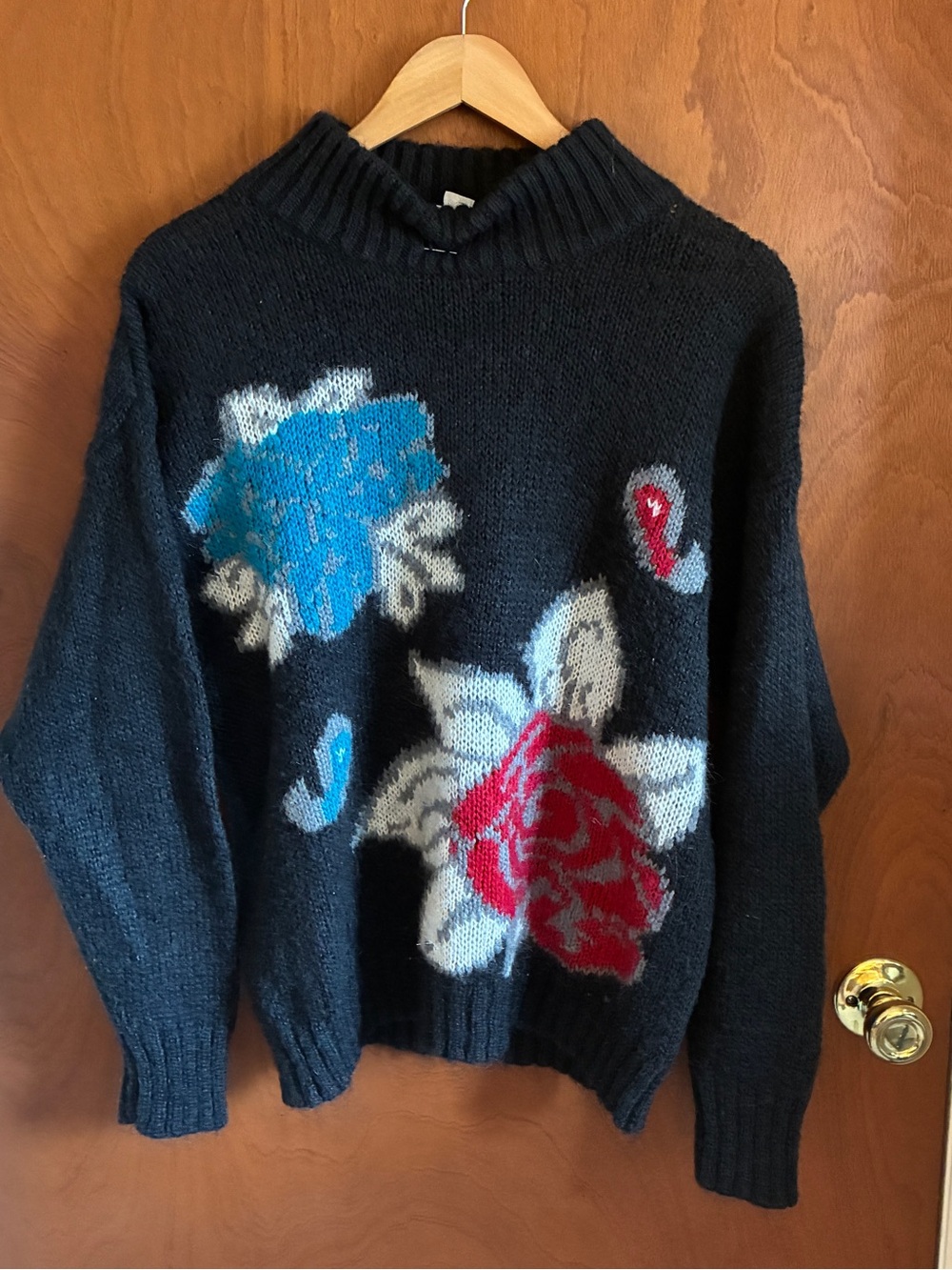 Black Floral Turtleneck Sweater with Blue and Red Blooms